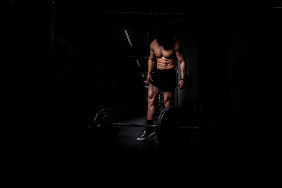 Man Lifting Weights on contrasted background